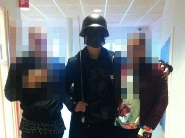 This picture, made available to AFP by a student, shows the masked man armed with a sword posing for a photo with two other students before attacking students and staff at the primary and middle school in Trollhattan, Sweden. The man, brandishing a sword broke into a school in Sweden, killing two people and seriously wounding two others before being shot by police. (AFP Photo) This picture, made available to AFP by a student, shows the masked man armed with a sword posing for a photo with two other students before attacking students and staff at the primary and middle school in Trollhattan, Sweden. The man, brandishing a sword broke into a school in Sweden, killing two people and seriously wounding two others before being shot by police. (AFP Photo)
