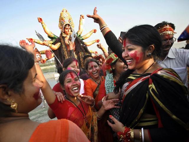 Devotees dance before immersing the idol of goddess Durga in the River Yamuna in New Delhi, India. (Arun Sharma/ Hindustan Times)