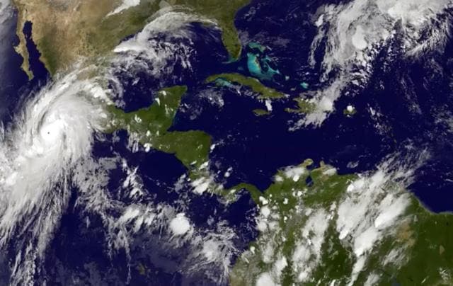 This satellite image taken at 845PM EDT on Thursday, October 22, 2015, and released by the National Oceanic and Atmospheric Administration shows Hurricane Patricia, left, moving over Mexico's central Pacific Coast. The powerful Category 4 storm bore down on Mexico's central Pacific Coast on Thursday night, for what forecasters said could be a devastating blow, as officials declared a state of emergency and handed out sandbags in preparation for flooding. (AP Photo) This satellite image taken at 845PM EDT on Thursday, October 22, 2015, and released by the National Oceanic and Atmospheric Administration shows Hurricane Patricia, left, moving over Mexico's central Pacific Coast. The powerful Category 4 storm bore down on Mexico's central Pacific Coast on Thursday night, for what forecasters said could be a devastating blow, as officials declared a state of emergency and handed out sandbags in preparation for flooding. (AP Photo)