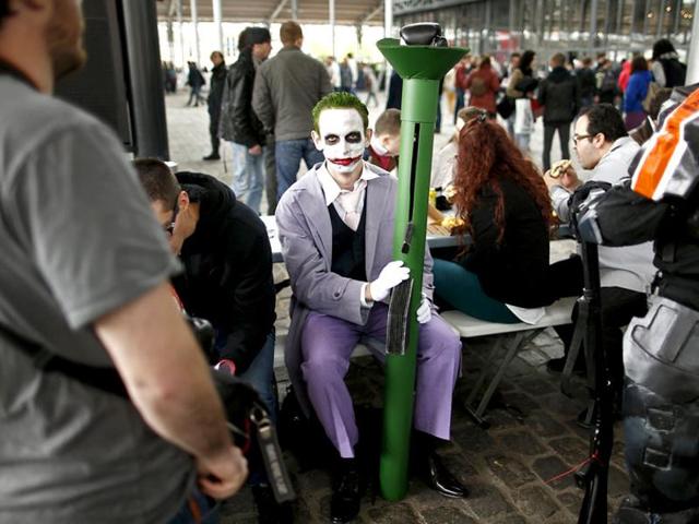A Paris Comic Con attendee dressed as Joker, a Batman character, waits during the first day of the event in Paris, October 23, 2015. (Reuters)