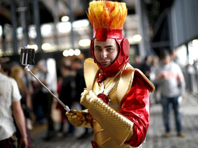 A Paris Comic Con attendee, dress as Firestorm, a DC character, poses during the event in Paris, October 23, 2015. (Reuters)