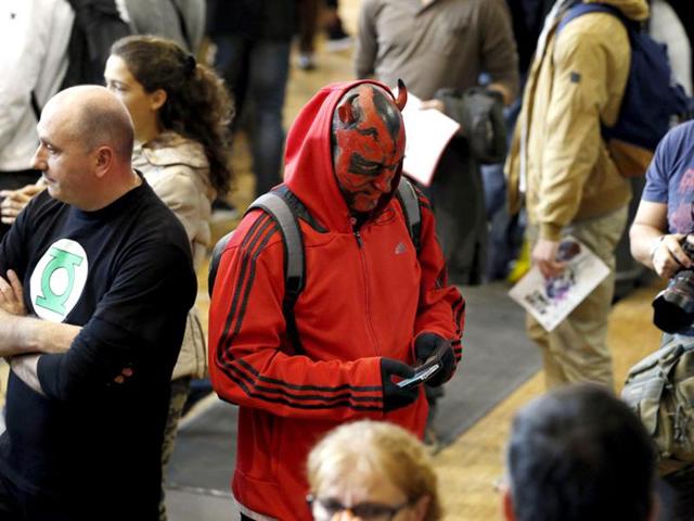 A man dressed up in a Star Wars character looks at his phone in Paris. The colourful pop culture event is expected to see at least 30,000 visitors. (AFP)