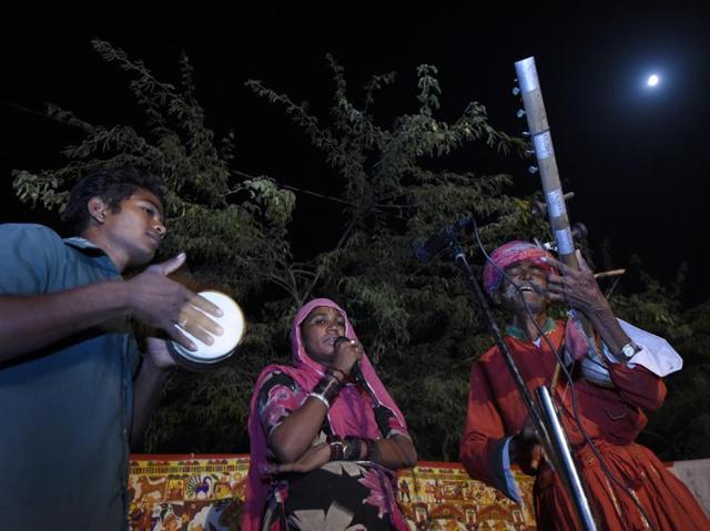 Tolaram Bhopa, a Raika, playing a musical instrument (extreme right) along with others from his family. The family is performing ‘Paboji ka phad’ for the village on the occasion of Dusshera at Ujaliya village. The Raikas are among 22 traditional Rajasthani folk forms being showcased at Rajasthan International Folk Festival. (Saumya Khandelwal/Hindustan Times)