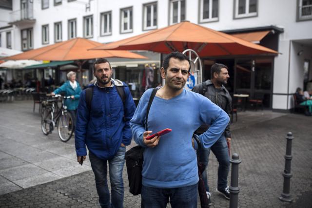 Osman al-Haj Osman, centre, walks across a street in Saarlouis, Germany, with his friends Mohammed al-Haj, left, and Dr. Ahmed Naasan, who recently arrived from Aleppo, Syria. (AP Photo) Osman al-Haj Osman, centre, walks across a street in Saarlouis, Germany, with his friends Mohammed al-Haj, left, and Dr. Ahmed Naasan, who recently arrived from Aleppo, Syria. (AP Photo)