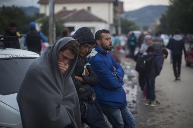 Mohammed al-Haj, in blue jacket, waits outside the hospital where Serbian authorities were registering refugees in the town of Presevo, on Friday, Sept. 11, 2015. Under a chilly drizzle that turned everything to mud, families huddled on sidewalks or around fires set in barrels. (AP Photo) Mohammed al-Haj, in blue jacket, waits outside the hospital where Serbian authorities were registering refugees in the town of Presevo, on Friday, Sept. 11, 2015. Under a chilly drizzle that turned everything to mud, families huddled on sidewalks or around fires set in barrels. (AP Photo)
