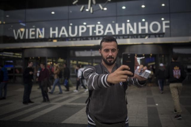 Mohammed al-Haj takes a selfie at the Vienna central train station in this photo taken on Monday, Sept. 14, 2015. After his release by the Hungarians, he turned to WhatsApp, consulting with other Syrians already in Germany who assured him that the Germans would take him in even if he had been registered with the Hungarians. (AP Photo) Mohammed al-Haj takes a selfie at the Vienna central train station in this photo taken on Monday, Sept. 14, 2015. After his release by the Hungarians, he turned to WhatsApp, consulting with other Syrians already in Germany who assured him that the Germans would take him in even if he had been registered with the Hungarians. (AP Photo)