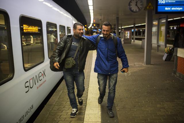 In this Wednesday, Sept. 16, 2015 photo, Mohammed al-Haj, right, and his friend Dr. Ahmed Naasan embrace each other after their arrival in Saarbrucken, western Germany. (AP Photo) In this Wednesday, Sept. 16, 2015 photo, Mohammed al-Haj, right, and his friend Dr. Ahmed Naasan embrace each other after their arrival in Saarbrucken, western Germany. (AP Photo)