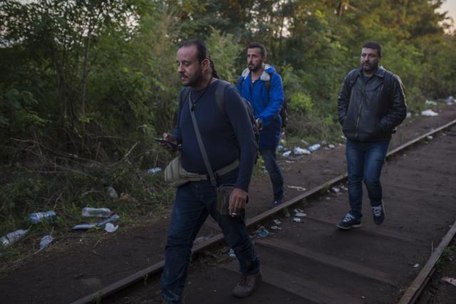 Mohammed al-Haj, centre, with his friends Dr. Mohanad Abdul-Qader, left, and Dr. Ahmed Naasan try to pass from the Serbian village of Horgos to Hungary. (AP Photo) Mohammed al-Haj, centre, with his friends Dr. Mohanad Abdul-Qader, left, and Dr. Ahmed Naasan try to pass from the Serbian village of Horgos to Hungary. (AP Photo)
