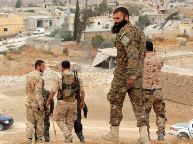 Syrian government forces walk in the village of Jabboul on the eastern outskirts of the northern Syrian city of Aleppo after taking control of the village from Islamic State. (AFP) Syrian government forces walk in the village of Jabboul on the eastern outskirts of the northern Syrian city of Aleppo after taking control of the village from Islamic State. (AFP)