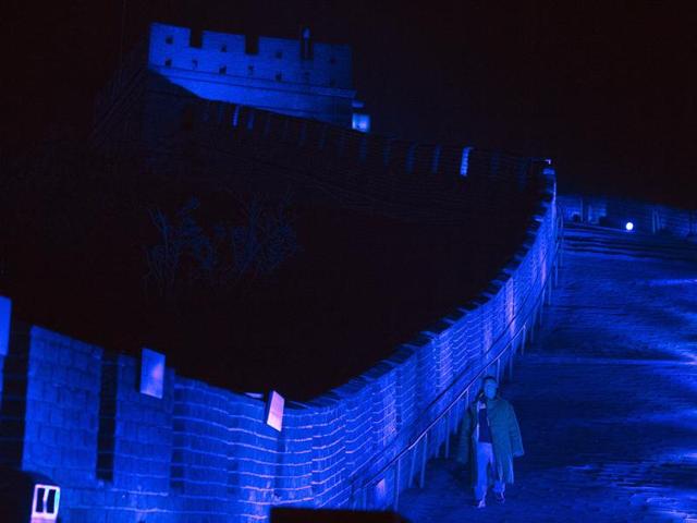 A worker walks along a section of the Great Wall of China lit by blue light to commemorate the 70th anniversary of the United Nations on the outskirts of Beijing, China. (AP Photo) A worker walks along a section of the Great Wall of China lit by blue light to commemorate the 70th anniversary of the United Nations on the outskirts of Beijing, China. (AP Photo)
