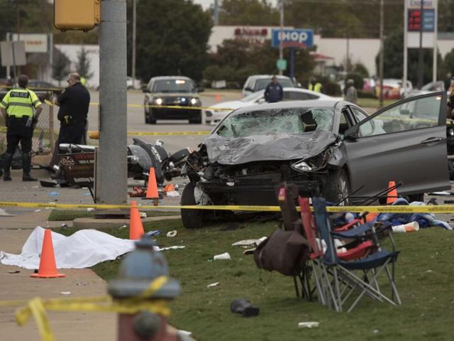 Emergency officials stand over the car that was involved after a suspected drunk driver crashed into a crowd of spectators during the Oklahoma State University homecoming parade near the Boone Pickens Stadium on October 24, 2015 in Stillwater, Oklahoma. (Getty images/AFP) Emergency officials stand over the car that was involved after a suspected drunk driver crashed into a crowd of spectators during the Oklahoma State University homecoming parade near the Boone Pickens Stadium on October 24, 2015 in Stillwater, Oklahoma. (Getty images/AFP)