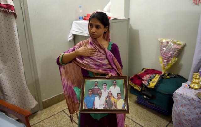 Geeta holds a photograph of a family in India which she believes is her family, during an AFP interview at the EDHI Foundation in Karachi. (AFP Photo) Geeta holds a photograph of a family in India which she believes is her family, during an AFP interview at the EDHI Foundation in Karachi. (AFP Photo)