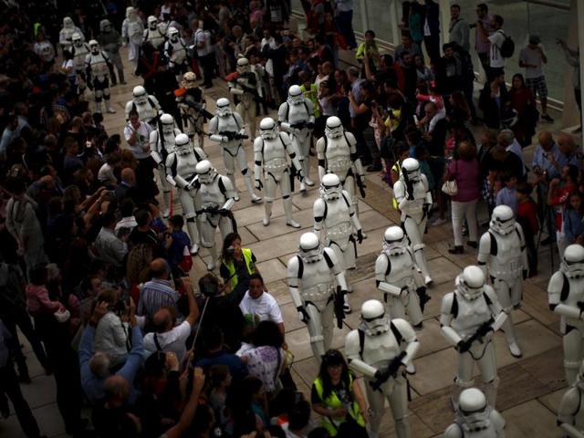People watch members of the 501st Legion Spanish Garrison dress up as characters from the movie Star Wars during a solidarity parade to spread the message of bone marrow donation and the fight against cancer. (REUTERS)