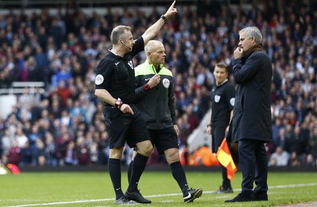 Jose Mourinho looks on as Referee Jonathan Moss sends to the stands goalkeeping coach Christophe Lollichon and assistant first team coach Silvino Louro (not pictured). (Reuters Photo) Jose Mourinho looks on as Referee Jonathan Moss sends to the stands goalkeeping coach Christophe Lollichon and assistant first team coach Silvino Louro (not pictured). (Reuters Photo)