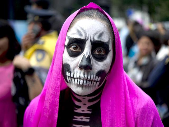 A public holiday, it sees families praying for the departed souls. The day also sees people dressed as La Calavera Catrina, a character created by cartoonist Jose Guadalupe Posada, participating in the Procession of the Catrinas. (AFP)