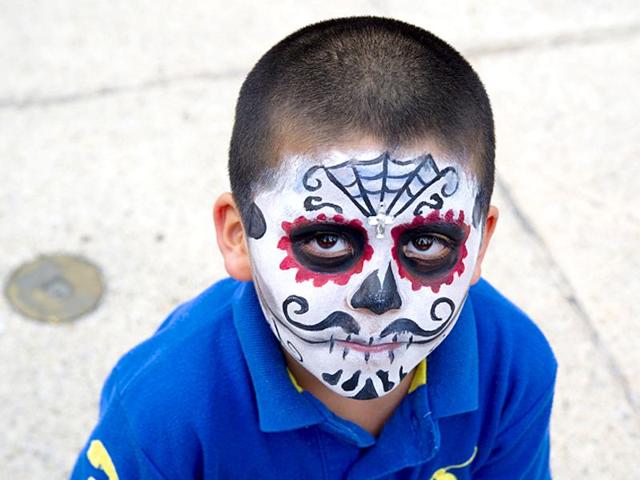 A boy painted as Catrin poses before taking part in the Procession of the Catrinas in Mexico City on October 25, 2015. (AFP)
