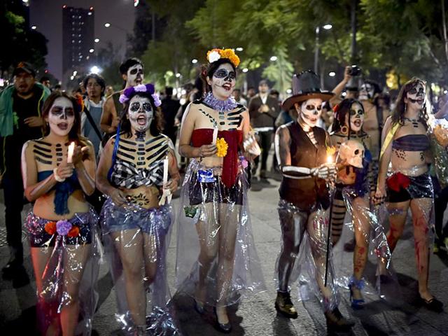 Women painted as Catrina take part in the Procession of the Catrinas in Mexico City. The cartoon character was popularised by artist Diego Rivera. (AFP)