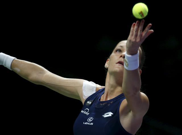 Agnieszka Radwanska serves to Maria Sharapova. (Reuters Photo) Agnieszka Radwanska serves to Maria Sharapova. (Reuters Photo)