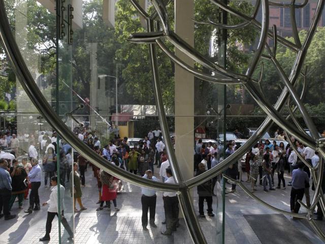 People gather outside HT House after strong tremors shook New Delhi on Monday. (Virendra Singh Gosain/ HT Photo)