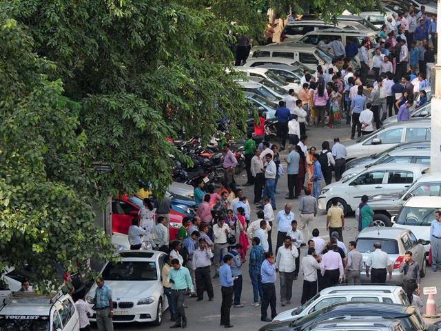 Office workers stand in an open area in a carpark following an earthquake in New Delhi. (AFP)
