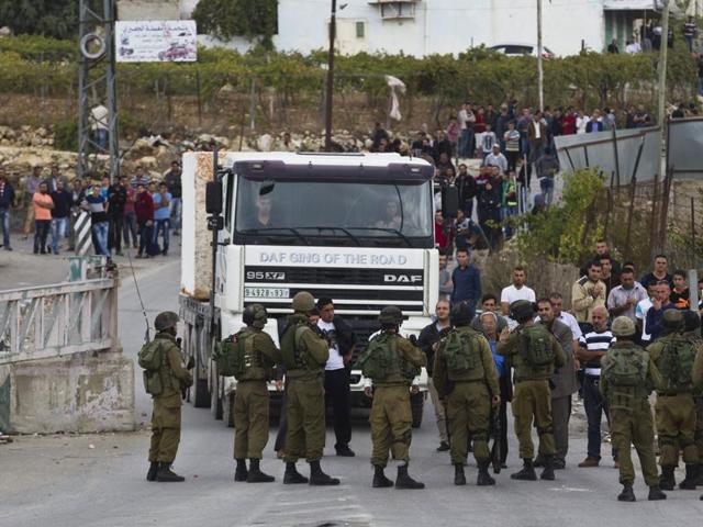 Israeli soldiers secure the area next to the scene of a stabbing attack near the West Bank town of Hebron. (REUTERS) Israeli soldiers secure the area next to the scene of a stabbing attack near the West Bank town of Hebron. (REUTERS)