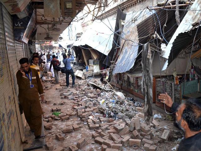 Pakistani residents gather at a damaged market following an earthquake in Sargodha . (AFP)
