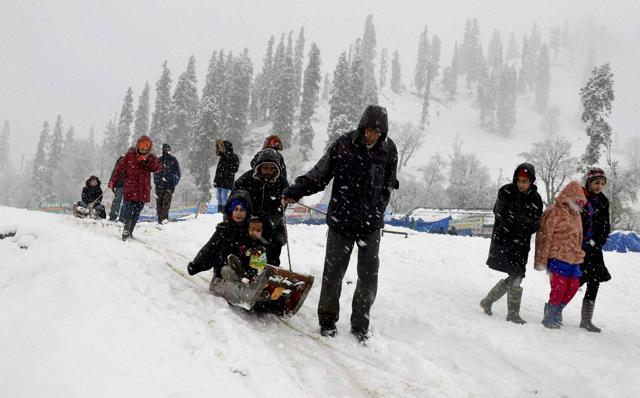 Tourists enjoy sledge ride during the season's first snowfall at famous Ski resort Gulmarg 55 km's from Srinagar on Saturday. (PTI) Tourists enjoy sledge ride during the season's first snowfall at famous Ski resort Gulmarg 55 km's from Srinagar on Saturday. (PTI)