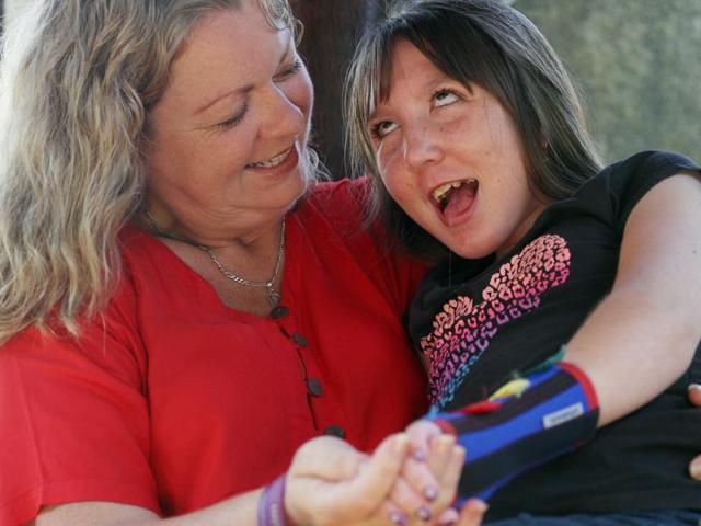 Jenn Hooper holds her daughter Charley, 10, in Bali, Indonesia.(AP/Firdia Lisnawati)