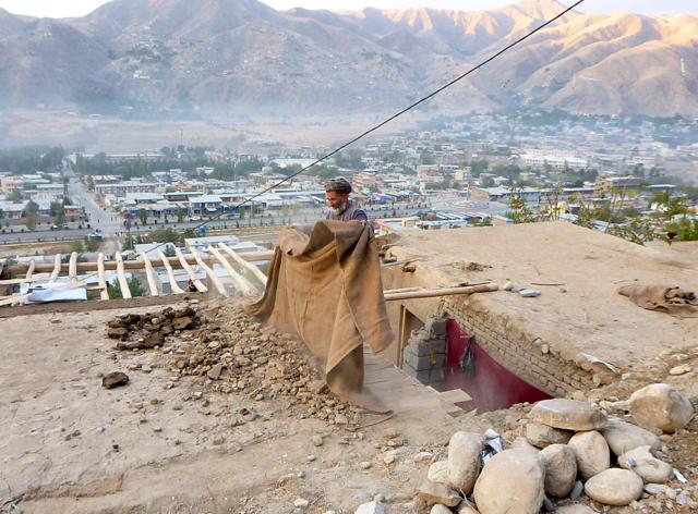 A man clears rubbles from the roof of his house after an earthquake, in Fayzabad capital of Badakhshan province, Afghanistan. (REUTERS Photo) A man clears rubbles from the roof of his house after an earthquake, in Fayzabad capital of Badakhshan province, Afghanistan. (REUTERS Photo)