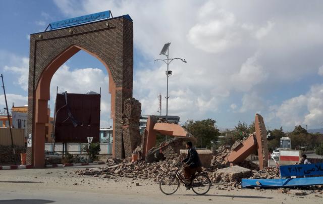 A man rides his bicycle next to damaged structures, after an earthquake in Ghazni, Afghanistan. (REUTERS Photo) A man rides his bicycle next to damaged structures, after an earthquake in Ghazni, Afghanistan. (REUTERS Photo)
