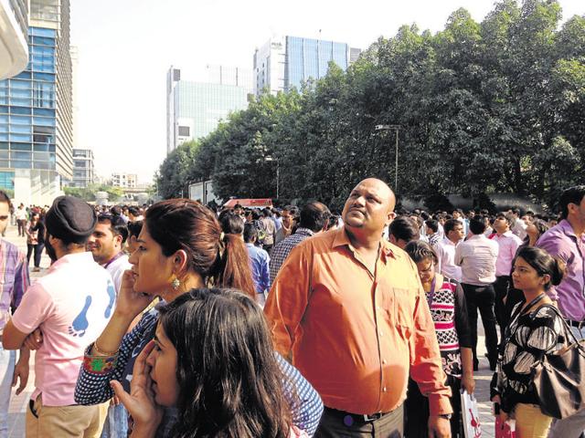 Office-goers at Cyber City in New Gurgaon rushed out after strong tremors jolted the city on Monday afternoon.(Gurinder Osan/HT Photo) Office-goers at Cyber City in New Gurgaon rushed out after strong tremors jolted the city on Monday afternoon.(Gurinder Osan/HT Photo)