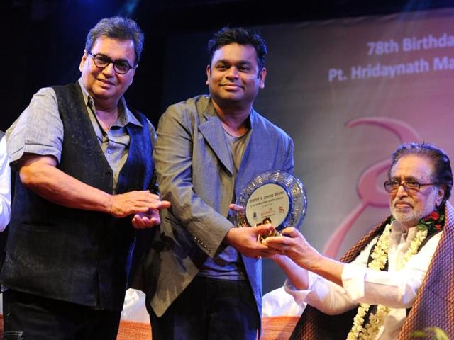Filmmaker Subhash Ghai (L) and Indian musician AR Rahman (C) pose with music composer Hridaynath Mangeshkar (R) during a function to celebrate his 78th birthday in Mumbai. (AFP)