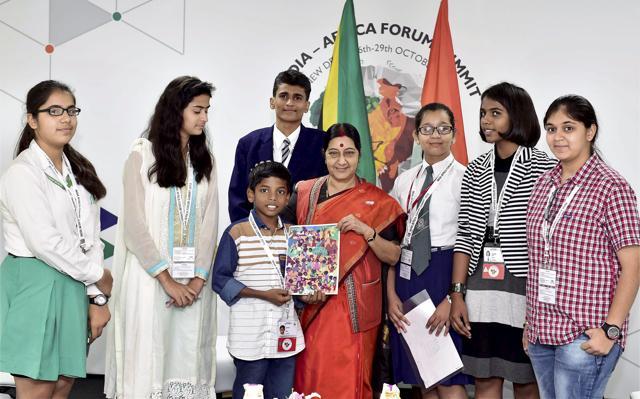External affairs minister Sushma Swaraj meets children who won a painting contest organised as a part of the India-Africa Forum Summit in New Delhi. (PTI)
