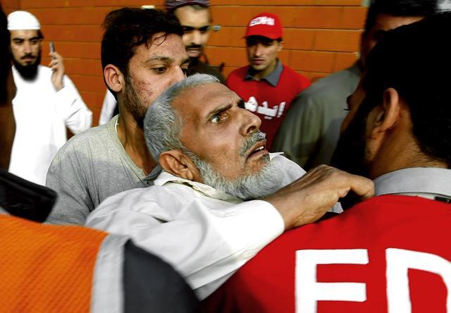 Pakistani rescue workers carry a traumatised person to a hospital in Peshawar, Pakistan. (AP) Pakistani rescue workers carry a traumatised person to a hospital in Peshawar, Pakistan. (AP)
