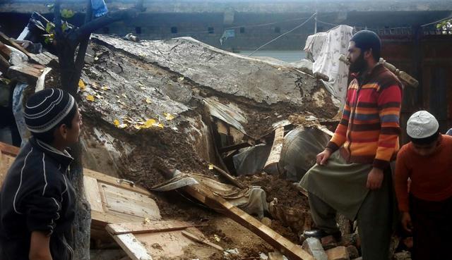 Pakistani residents stand over debris of their house collapsed by an earthquake in Qabal near Mingora in Swat valley, Pakistan. (AP) Pakistani residents stand over debris of their house collapsed by an earthquake in Qabal near Mingora in Swat valley, Pakistan. (AP)