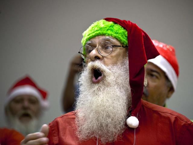 People sing during a lesson at a school for Santa Claus in Rio de Janeiro on October 27, 2015. (AFP)