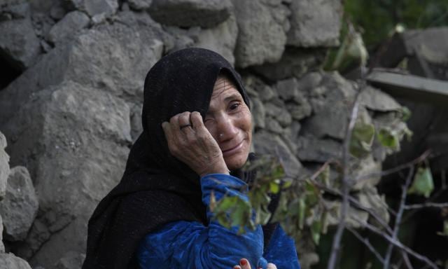 A Pakistani woman, who lost her two grandsons in Monday's earthquake, mourns as she sits on the rubble of her destroyed house in Jinjara village in Chitral, a district of Northern Pakistan. (AP Photo) A Pakistani woman, who lost her two grandsons in Monday's earthquake, mourns as she sits on the rubble of her destroyed house in Jinjara village in Chitral, a district of Northern Pakistan. (AP Photo)