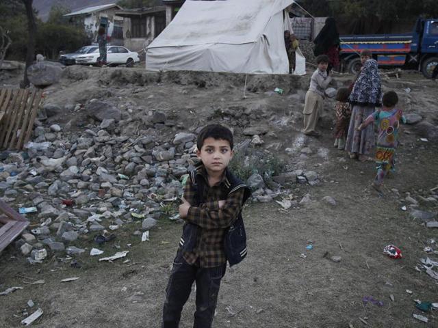 Pakistani children stand near homes damaged from Monday's earthquake in Jinjara village in Chitral, a district of Northern Pakistan. (AP Photo) Pakistani children stand near homes damaged from Monday's earthquake in Jinjara village in Chitral, a district of Northern Pakistan. (AP Photo)