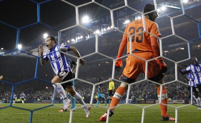 Ross Wallace, left, celebrates scoring the first goal for Sheffield Wednesday as Arsenal keeper Petr Cech looks on. (Reuters Photo)