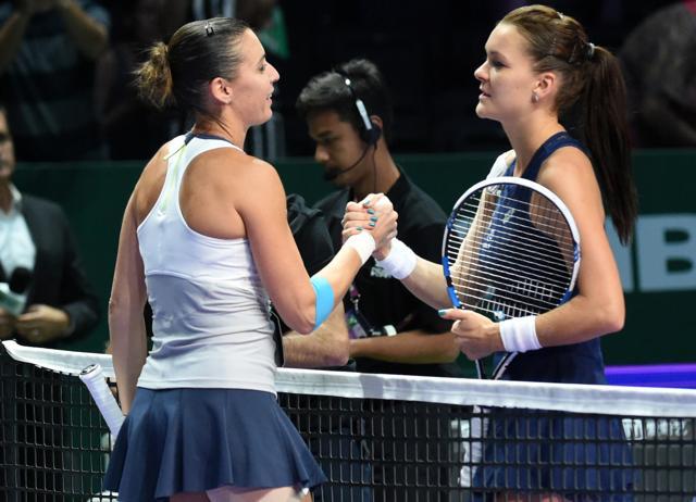 Italy's Flavia Pennetta, left, and Poland's Agnieszka Radwanska shake hands at the net after the Italian won their match at the WTA Finals in Singapore on October 27, 2015. (AFP Photo) Italy's Flavia Pennetta, left, and Poland's Agnieszka Radwanska shake hands at the net after the Italian won their match at the WTA Finals in Singapore on October 27, 2015. (AFP Photo)
