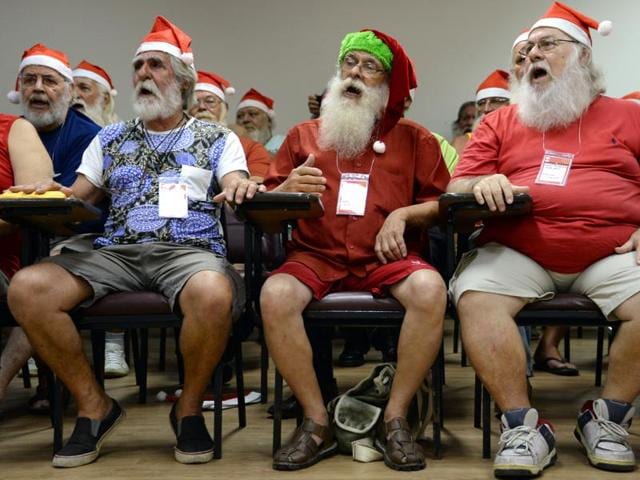 People sing during a lesson at a school for Santa Claus in Rio de Janeiro on October 27, 2015. (AFP)