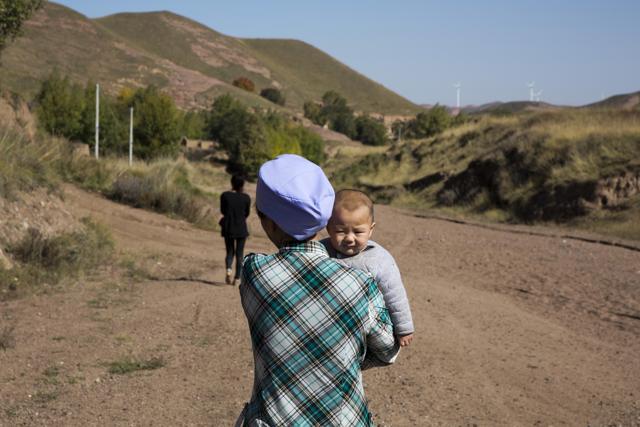Yao Xiaohua, 46, holds her granddaughter Yang Liping near their home in Dacha village of Xiji county in northwestern China's Ningxia Hui autonomous region. (AP) Yao Xiaohua, 46, holds her granddaughter Yang Liping near their home in Dacha village of Xiji county in northwestern China's Ningxia Hui autonomous region. (AP)