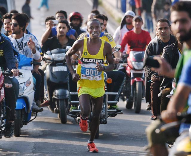 Nigerian athlete Titus from Nigeria (winner) takes part in the first International Kashmir half Marathon, at Foreshore road at the banks of Dal Lake in Srinagar. (PTI) Nigerian athlete Titus from Nigeria (winner) takes part in the first International Kashmir half Marathon, at Foreshore road at the banks of Dal Lake in Srinagar. (PTI)