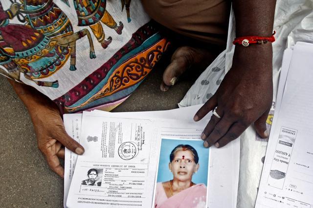 Relatives of Kasthuri Munirathinam display a photo of her and copies of her employment documents, in Chennai. (AP) Relatives of Kasthuri Munirathinam display a photo of her and copies of her employment documents, in Chennai. (AP)