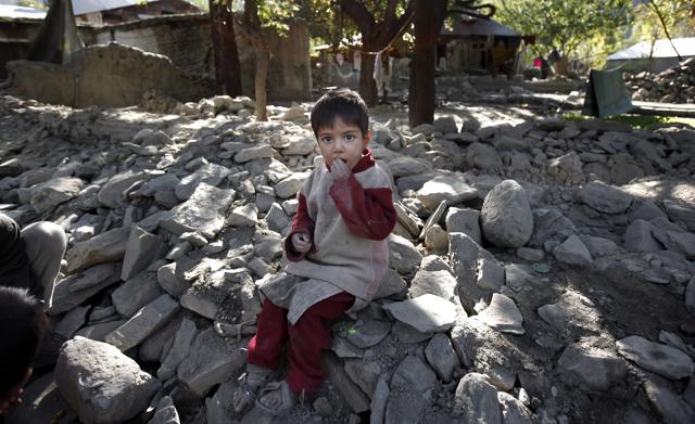 A child eats peanuts as he sits on the rubble of a destroyed house caused by Monday's earthquake in Chitral town, northern Pakistan. People in the Pakistani town of Chitral, one of the closest to the quake's epicentre, say they are too poor to rebuild their homes and need government help. (AP Photo) A child eats peanuts as he sits on the rubble of a destroyed house caused by Monday's earthquake in Chitral town, northern Pakistan. People in the Pakistani town of Chitral, one of the closest to the quake's epicentre, say they are too poor to rebuild their homes and need government help. (AP Photo)