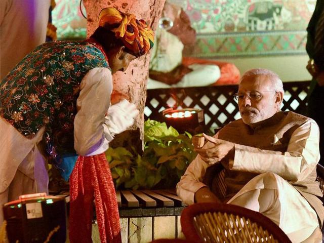 Prime Minister Narendra Modi is offered tea at a traditional dinner hosted for India Africa Forum Summit delegations' heads at Pragati Maidan in New Delhi. (PTI Photo)