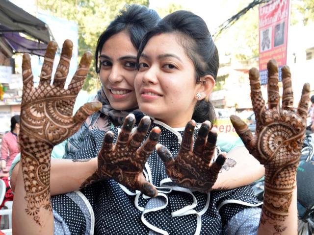 Celebrating with great fervour, married women showing mehndi on their hands on the eve of Karva Chauth in Amritsar on Thursday. (Sameer Sehgal/ HT photo)
