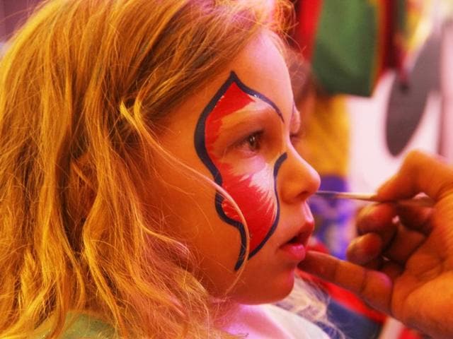 A child patiently waits while her face is being painted at the Halloween party in Lower Parel, Mumbai. (Pramod Thakur/HT photo)
