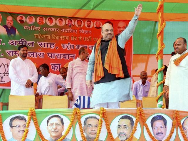 Prime Minister Narendra Modi waves as BJP leaders CP Thakur and Sushil Kumar Modi look on during an election rally near Patna(PTI Photo) Prime Minister Narendra Modi waves as BJP leaders CP Thakur and Sushil Kumar Modi look on during an election rally near Patna(PTI Photo)