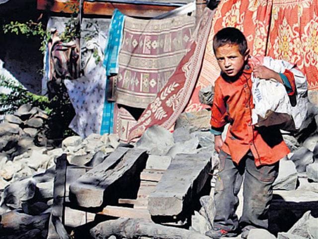 A child at his home which was destroyed by Monday’s quake.(AP Photo)